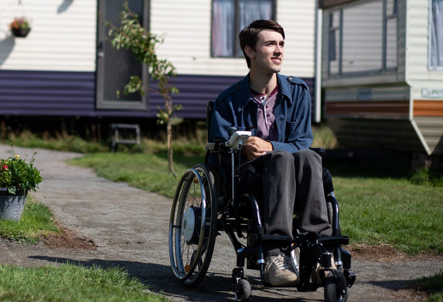 George Robinson, who plays Isaac in Sex Education, in his wheelchair on set.