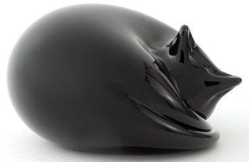 sleek black cat paperweight in the shape of a sleeping cat