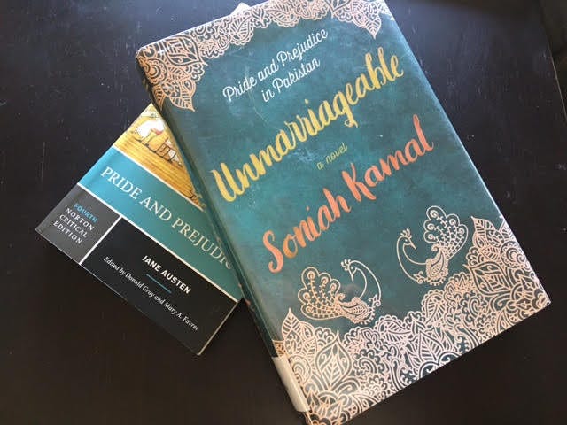 A hardcover of Soniah Kamal's book 'Unmarriageable' sits above a paperback copy of Jane Austen's 'Pride and Prejudice'