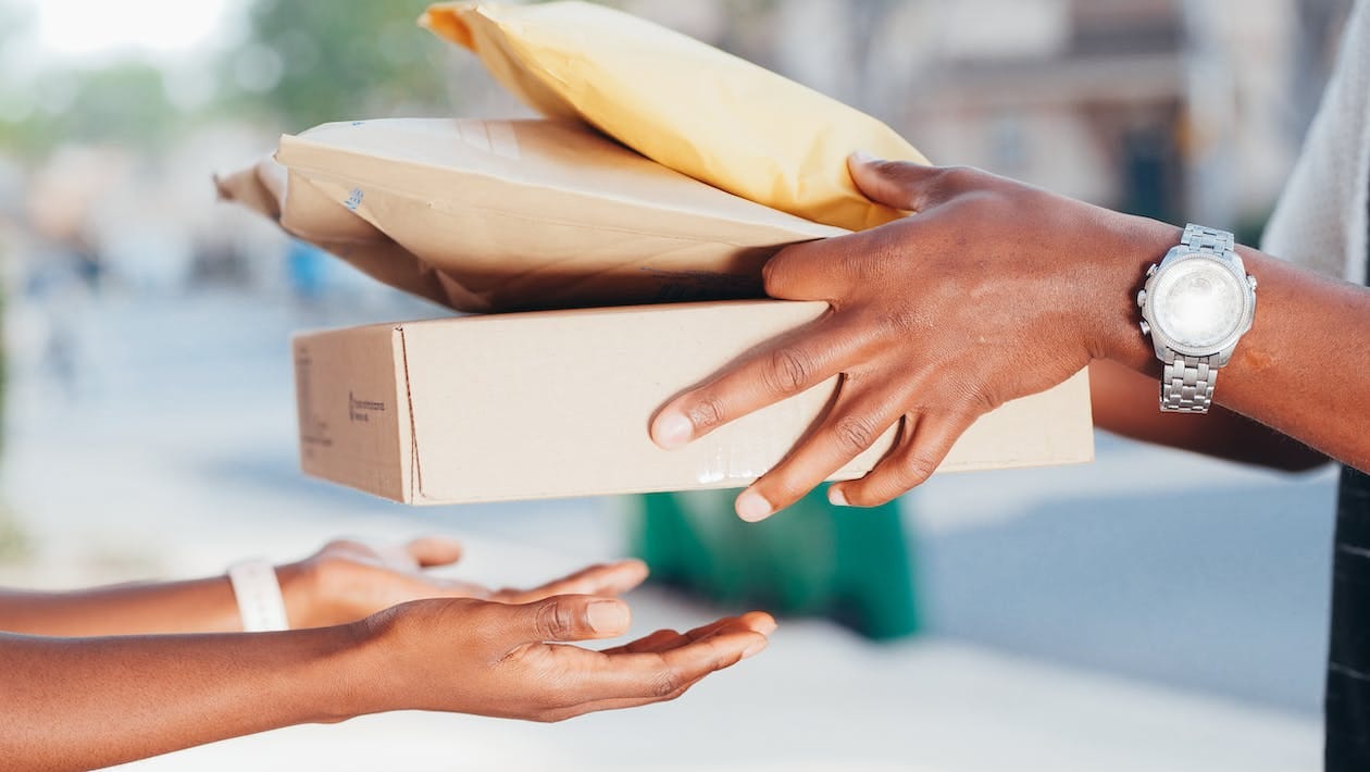 Free Person Handing Over Packages Stock Photo