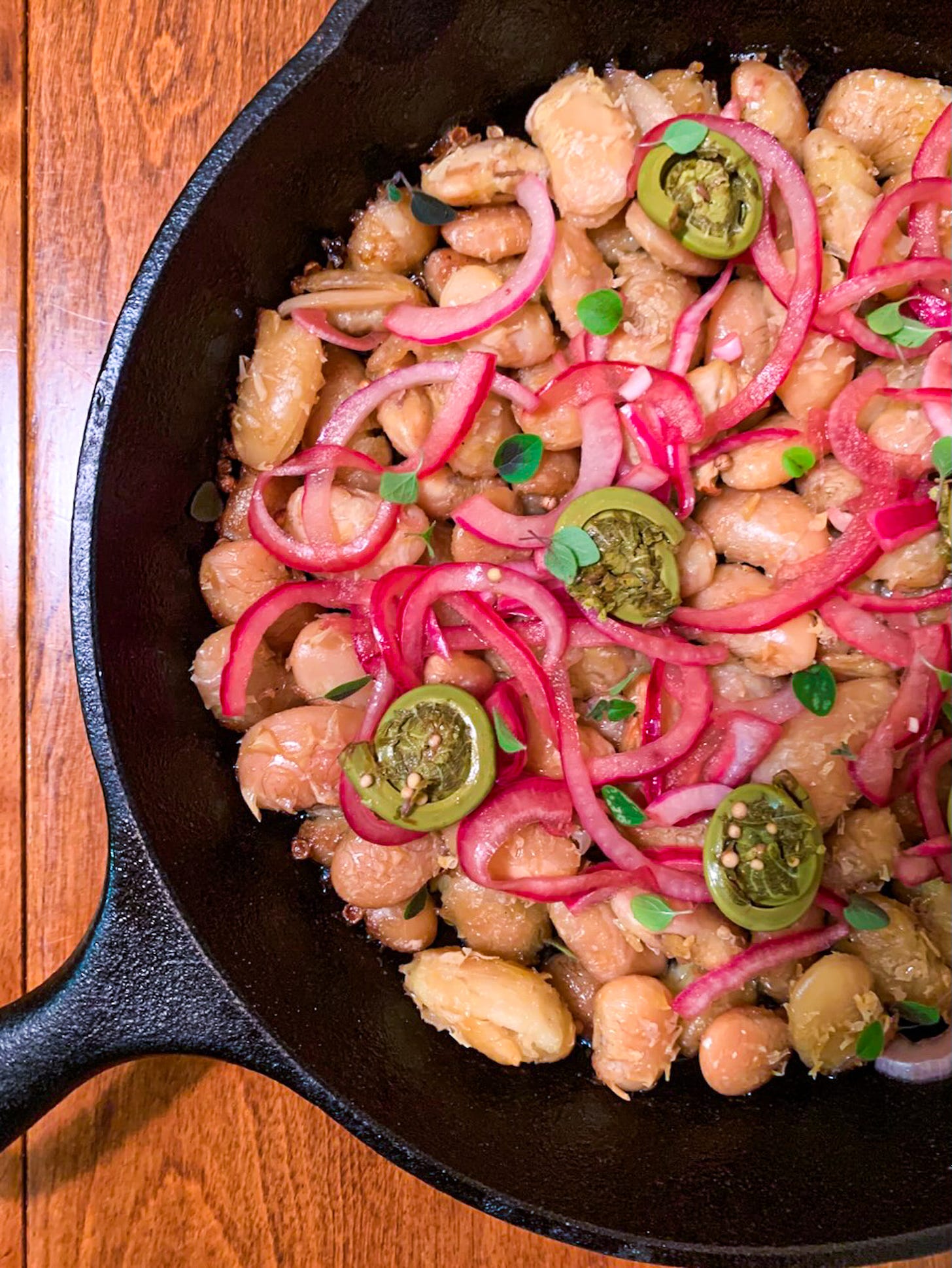 Confited beans in cast iron pan