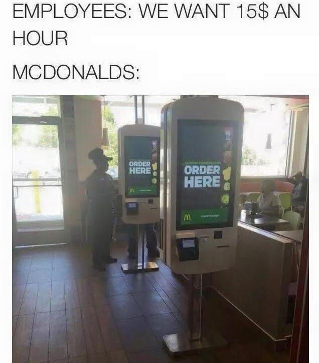 May be an image of 1 person, phone and text that says 'EMPLOYEES: WE WANT 15$ ΑΝ HOUR MCDONALDS: ORDER HERE ORDER HERE 8'