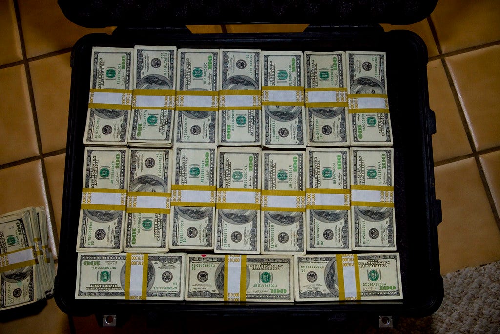 The obligatory suitcase full of cash shot