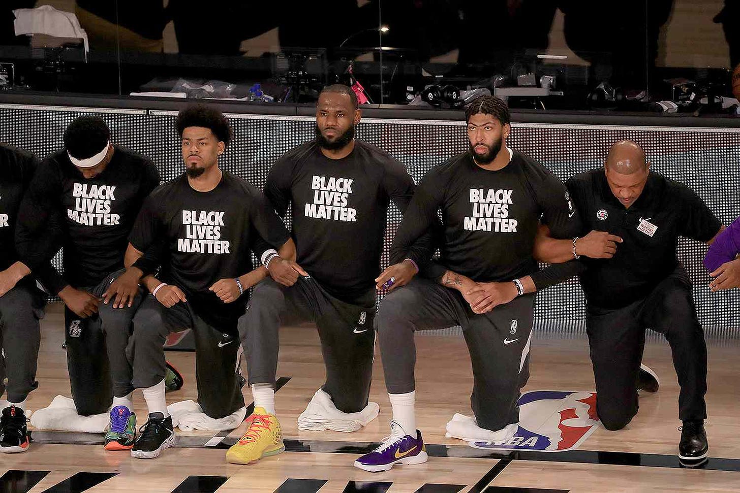 Image result from https://people.com/sports/lebron-james-fellow-nba-players-kneel-for-national-anthem-in-black-lives-matter-shirts/