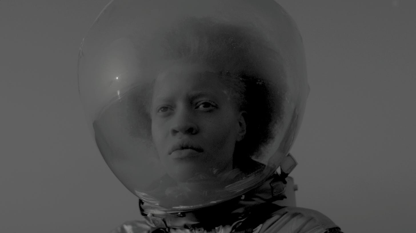 A black and white photo of a black woman in a space helmet from the film Afronauts
