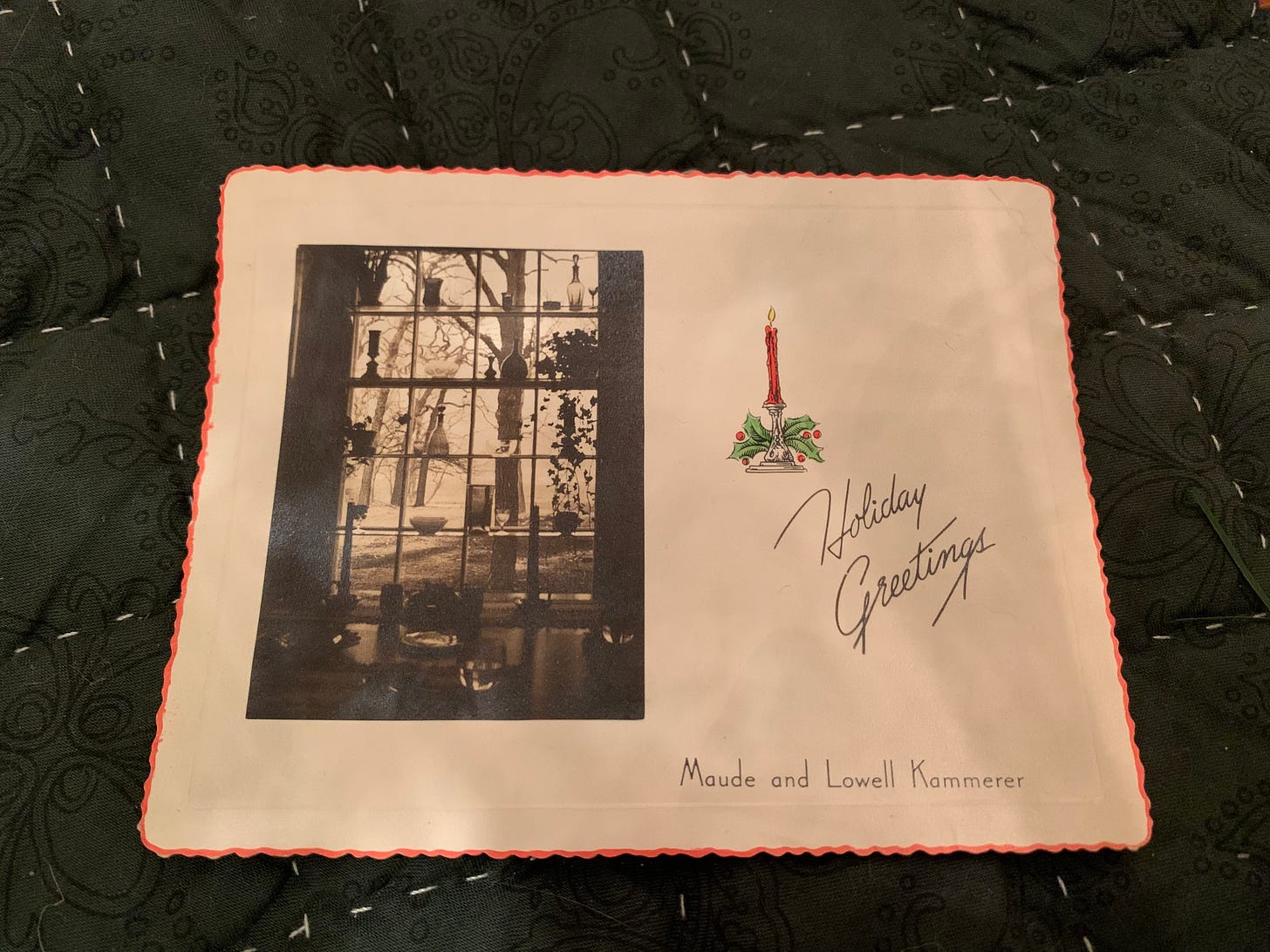 White cardstock with scalloped edges dipped in red ink. On the left is a photo of a bay window with shelves and on the right text reads “Holiday Greetings, Maude and Lowell Kammerer.”