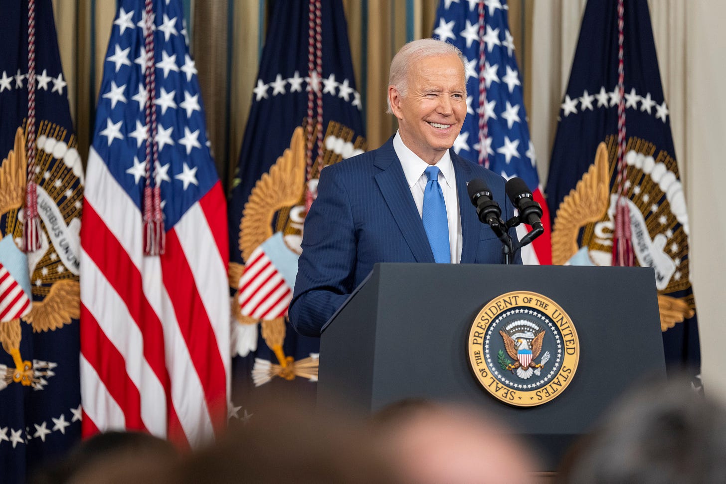 President Biden delivers remarks at a podium.