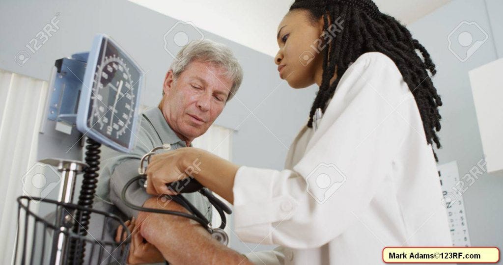 woman doctor checking patient's blood pressure