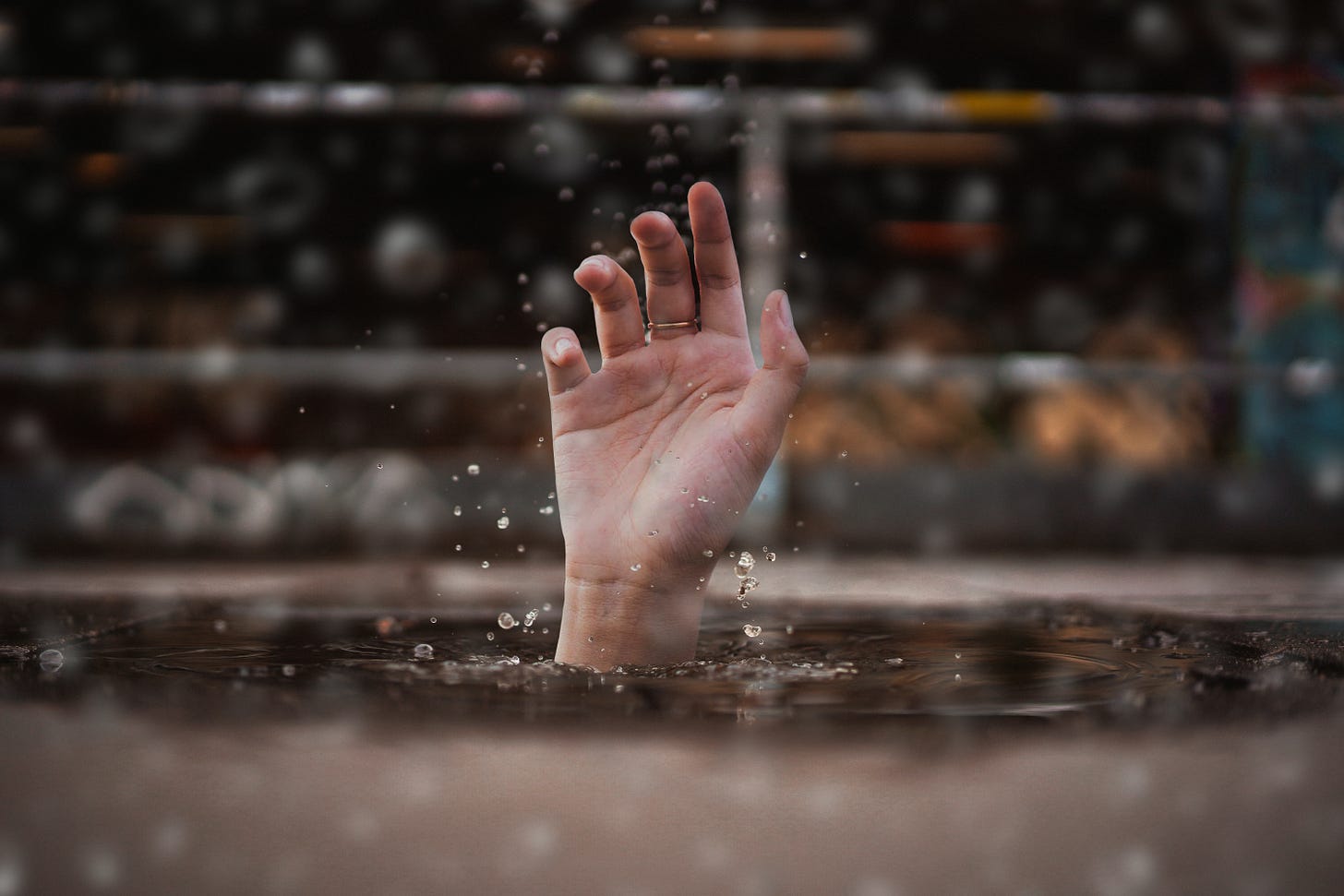 A hand rising up from the water.
