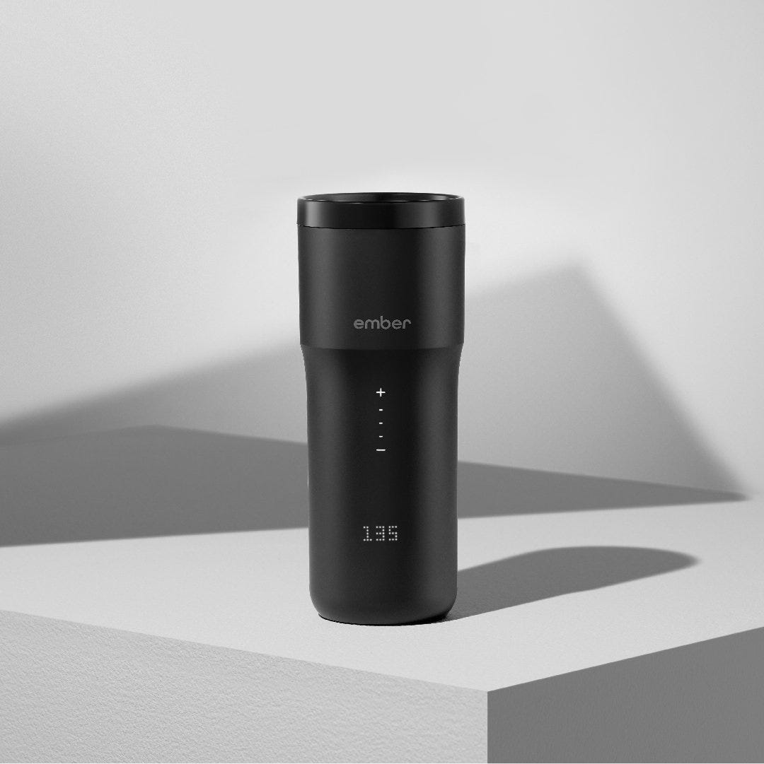 Black 12 ounce Ember Travel Mug² showcased on a white pedestal and white background