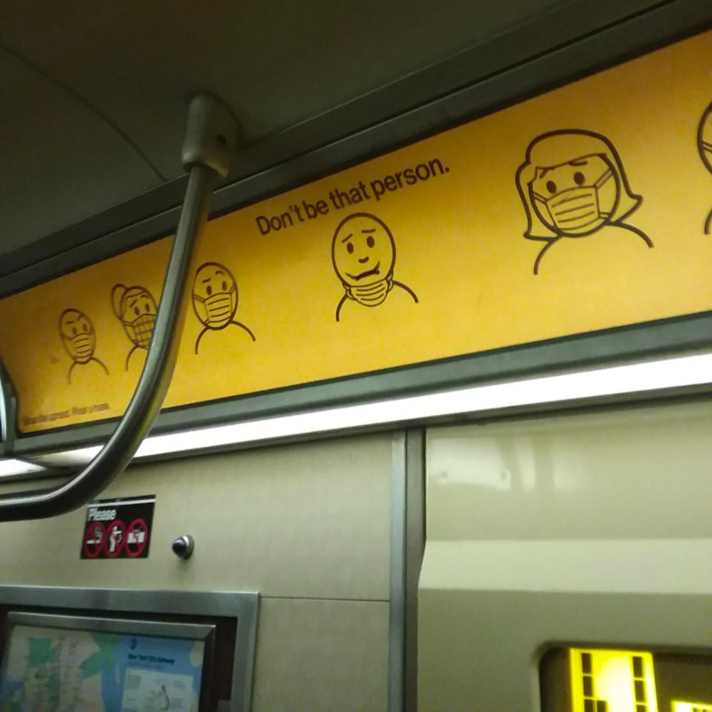 photo of a public transit advertisement sign with drawings of several masked people and one person with their mask under their chin with the caption Dont be that person