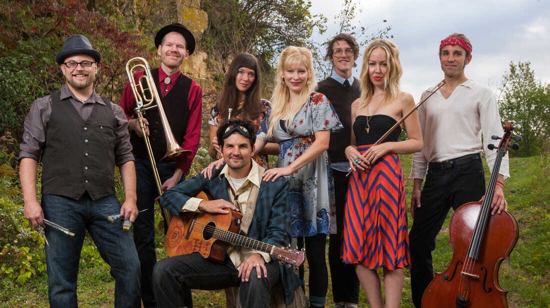 Men and women with various instruments who make up the band, Cloud Cult