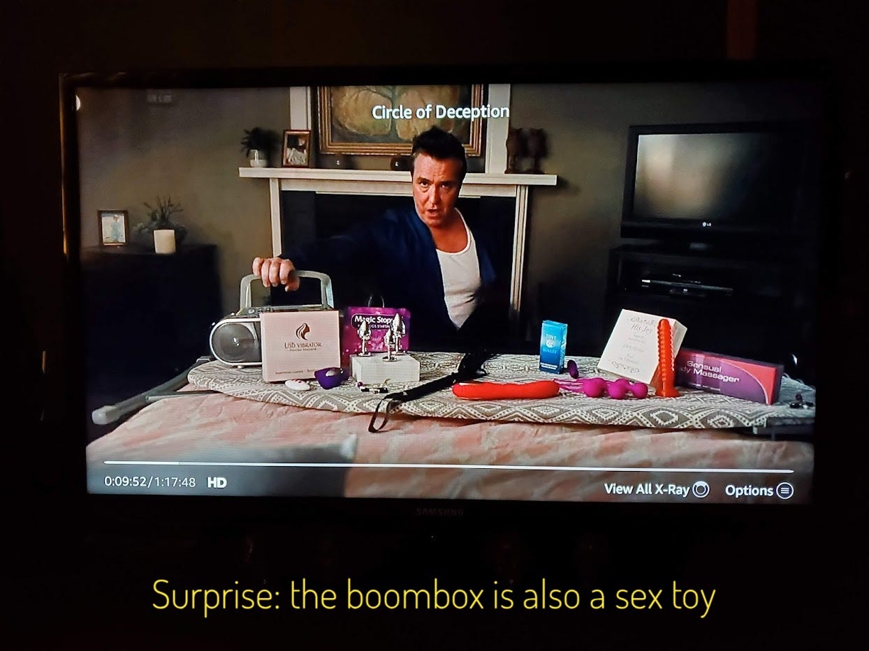 Russel, in a tanktop and bathrobe, behind a bed strewn with so many sex toys and a boombox playing sexy music. Captioned "Surprise: the boombox is also a sex toy"