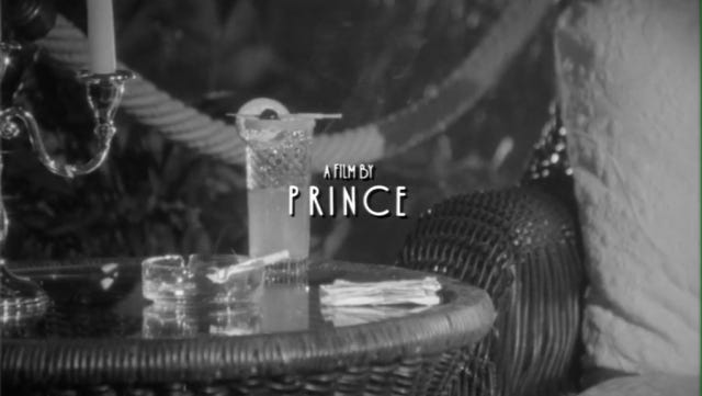 Title card 'A Film by Prince' in front of an image of a cigarette in an ash tray and a cocktail