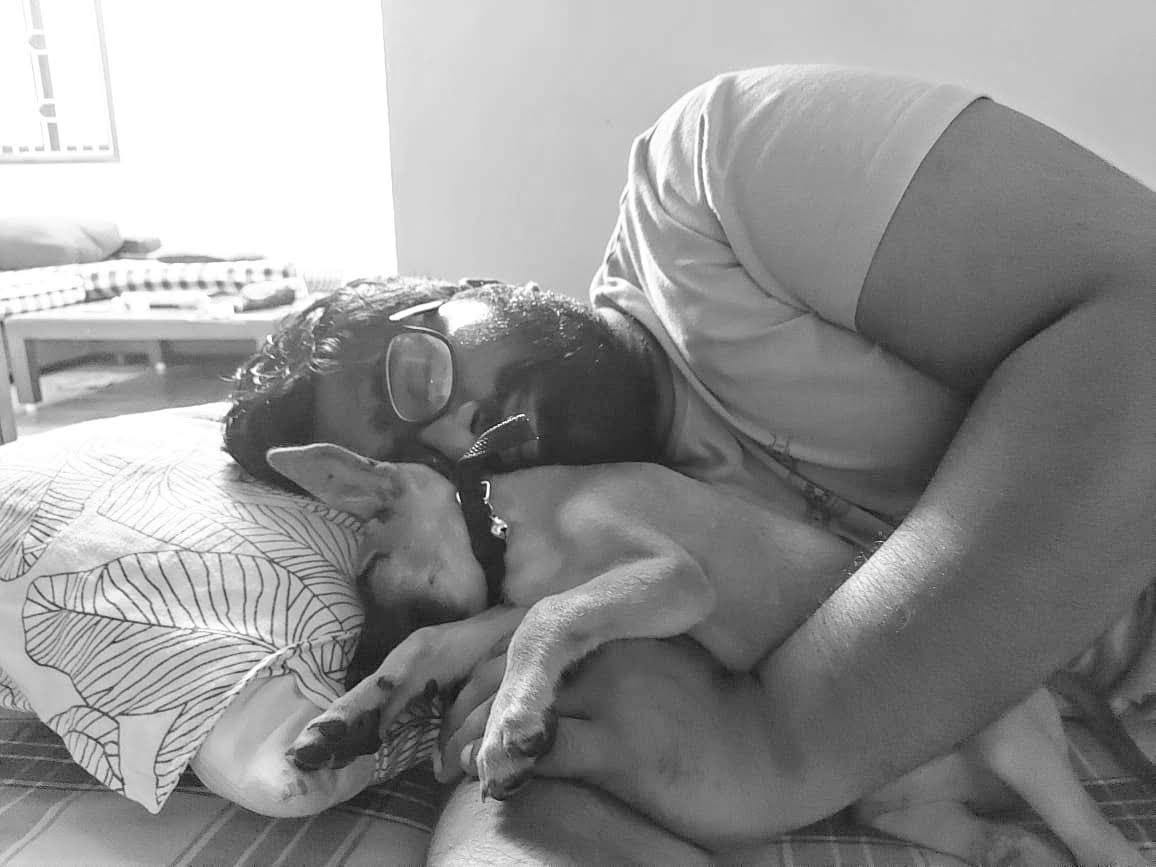 Jason Samuel sleeping along his puppy Morty