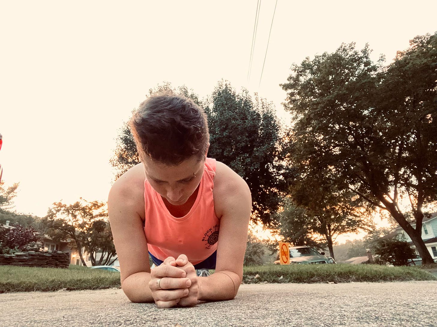 short brown haired jogger doing a plank