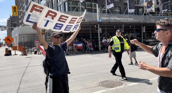 David interviewing a protestor in Ottawa July 2022.