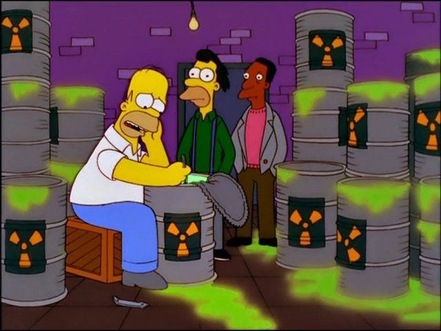 Simpsons characters sitting on drums of radioactive waste.