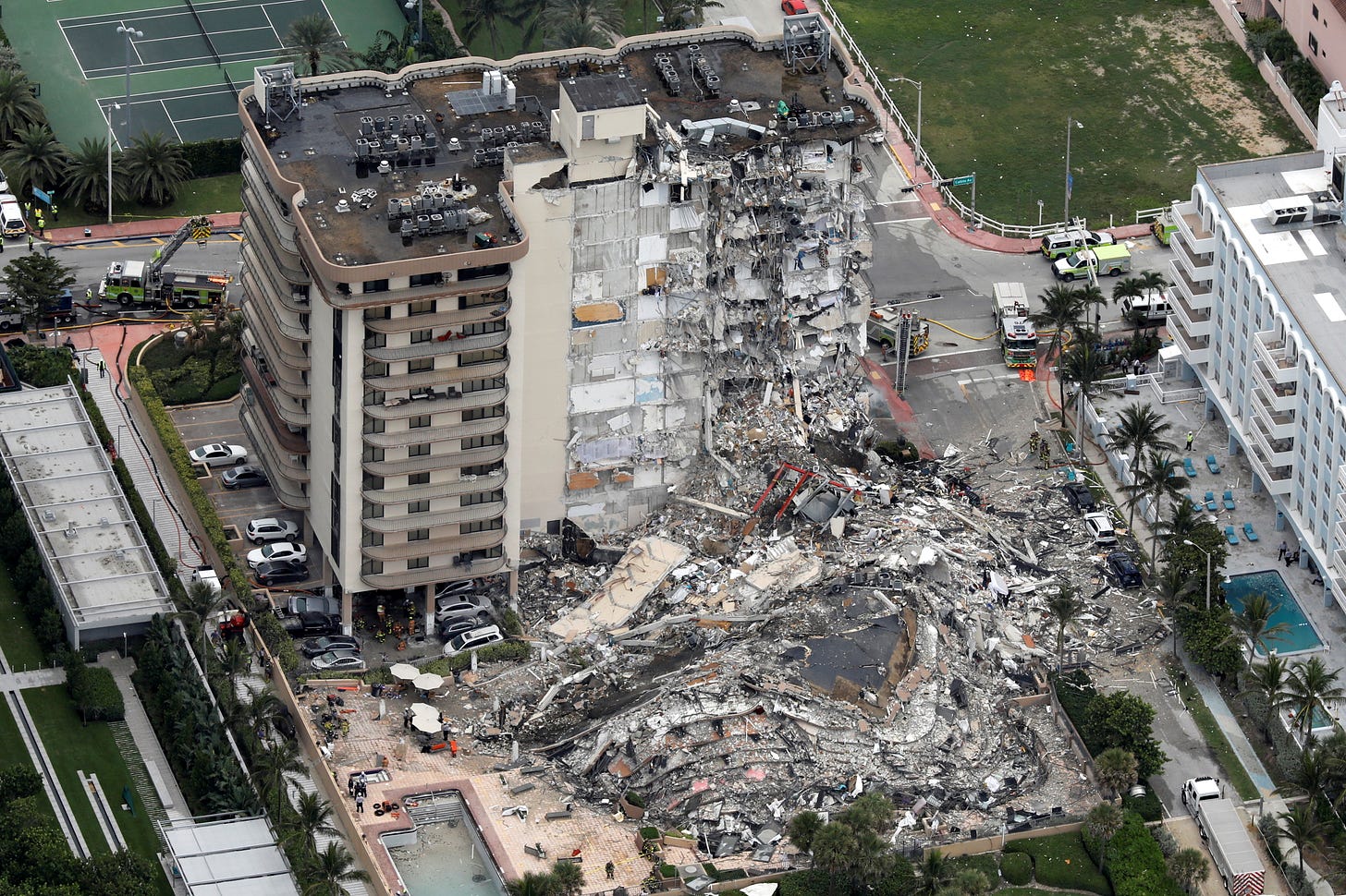 Nearly 100 people missing as oceanfront Miami-area building collapses |  Reuters