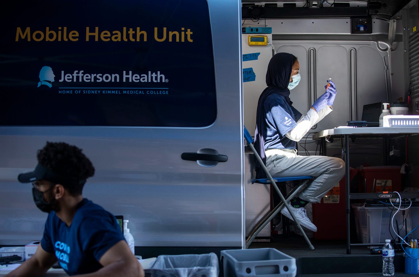 Pharmacist Hajar Mokhlis prepares vaccines in the Jefferson Health Mobile Health Unit during a pop-up COVID-19 vaccination clinic hosted by Jefferson Health outside of South Philly Barbacoa at Ellsworth and South 9th Streets in Philadelphia, Pa. on Sunday, May 23, 2021. Attendees could get a free taco after getting vaccinated.