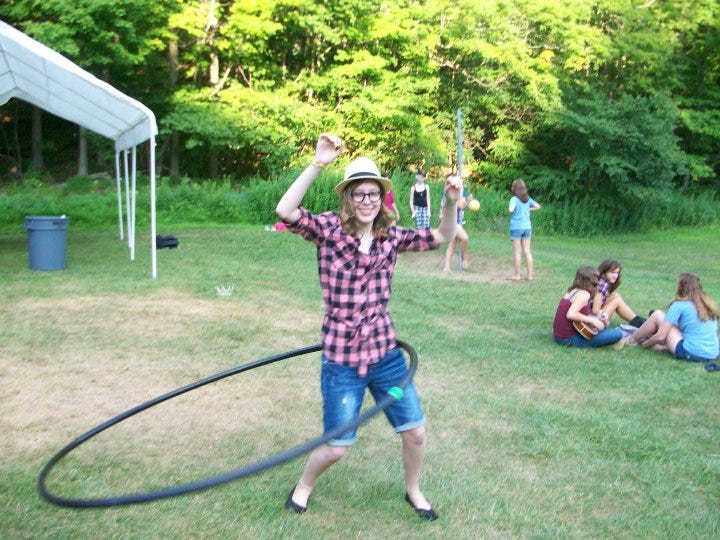 Me as a 15-year-old in a plaid shirt, thick glasses, and a fedora in a hula loop