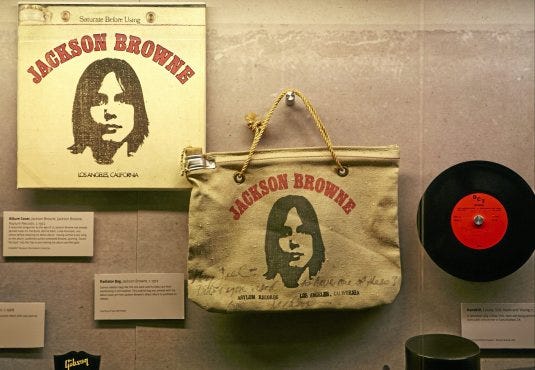 In this Friday, May. 9, 2014, photo, Songwriter Jackson Browne's classic L.P. cover, and the original radiator bag printed with the album cover art from Jackson Browne's debut album to promote its release, are displayed at the Grammy Museum exhibit "California Dreamin': The Sounds of Laurel Canyon, 1965 - 1977," in Los Angeles. (AP Photo/Damian Dovarganes)