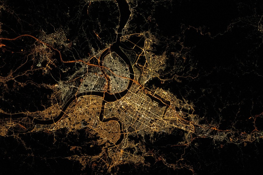 Bright lines detail a web of city streets, while dark lanes show the outlines of rivers.