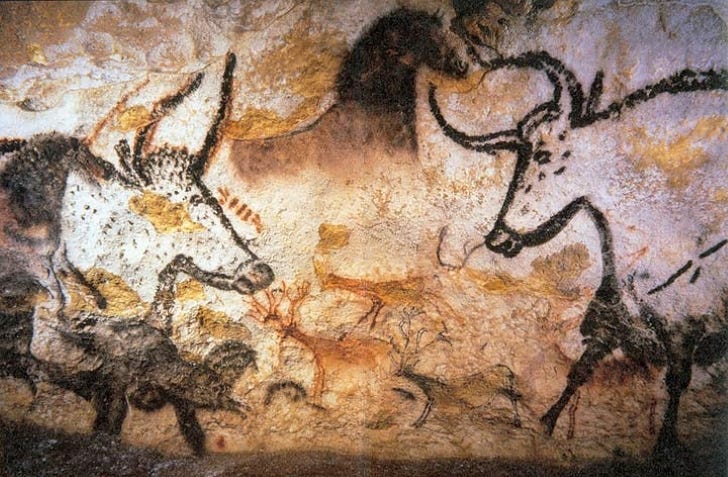 Photograph of ancient Lascaux cave painting featuring images of aurochs, horses, and deer.