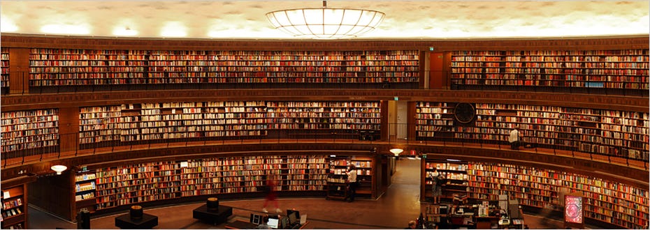 A photograph of three floors full of bookshelves belonging to the Stockholm public library.