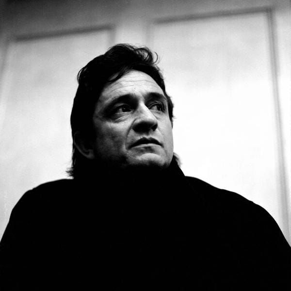 Johnny Cash in black, looking to the distance