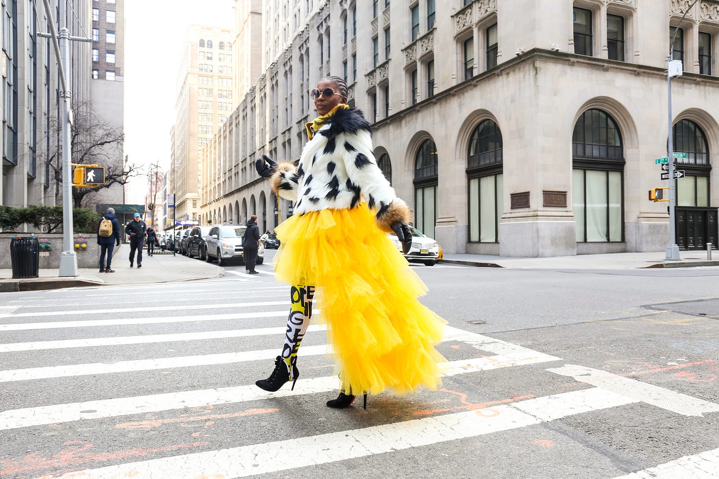 woman wearing yellow and white dress passing on road photo