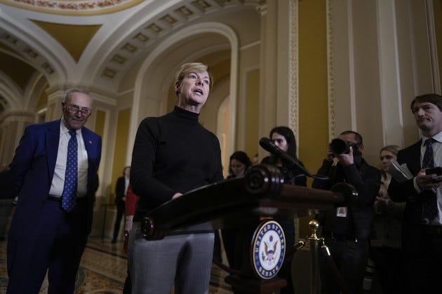 Sen. Tammy Baldwin, center, joins Senate Majority Leader Chuck Schumer to talk.