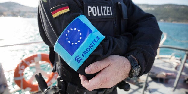 A police officer with a Frontex armband.
