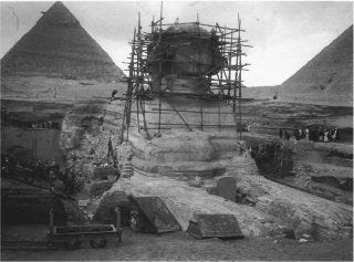 The Great Sphinx, with the restoration scaffolding of Emile Baraize, looking northwest, December 26, 1925. The pyramids of Khufu (right) and Khafre (left) are in the background.
