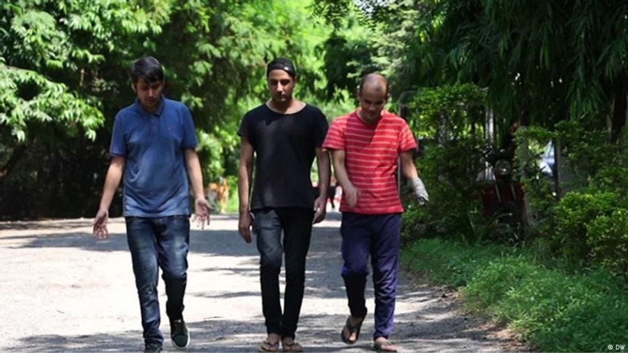 A group of men walking on a path in the woods

Description automatically generated with medium confidence
