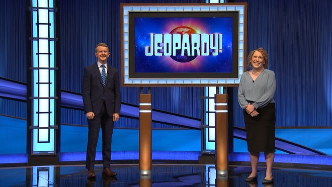 Amy Schneider, a "Jeopardy!" competitor, poses with host Ken Jennings.