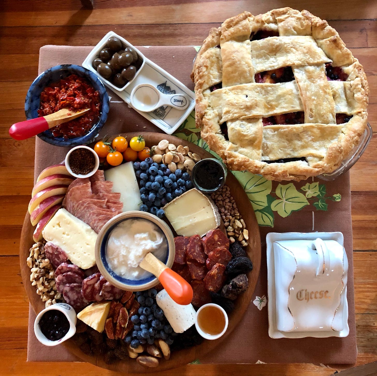 a cheese plate and a pie, with a china cheese cover