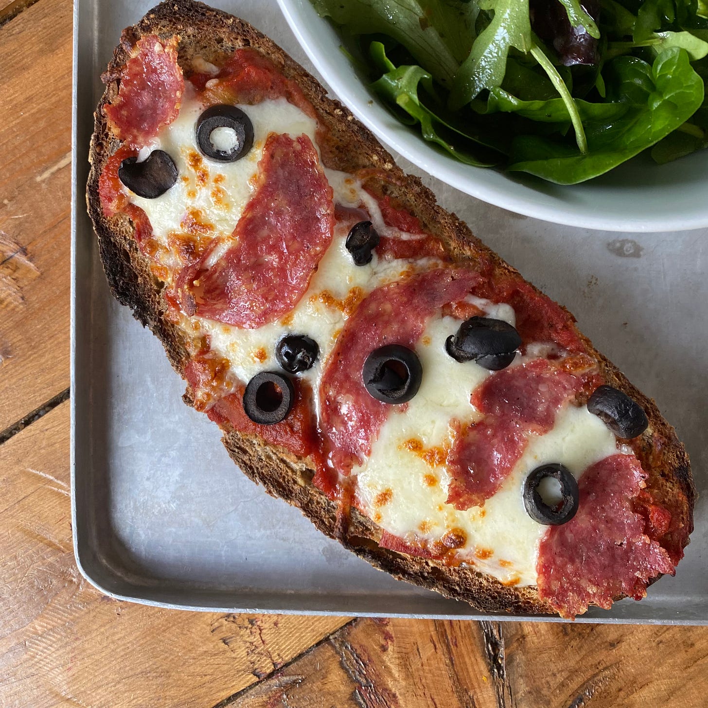Pizza toast with a green salad
