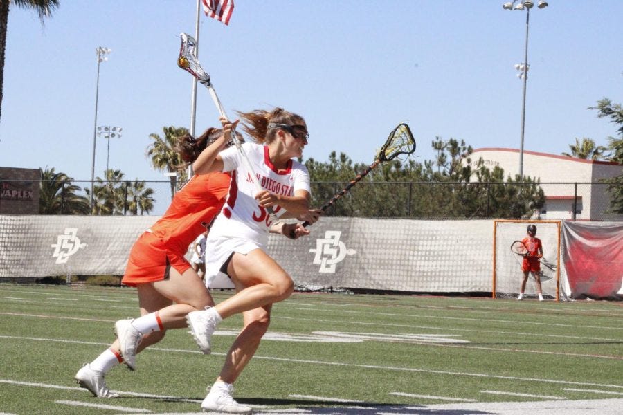 Senior+Shelby+Hook+%28%2338%29+trying+to+get+around+a+Princeton+attacker%2Fmidfielder+on+March+12.
