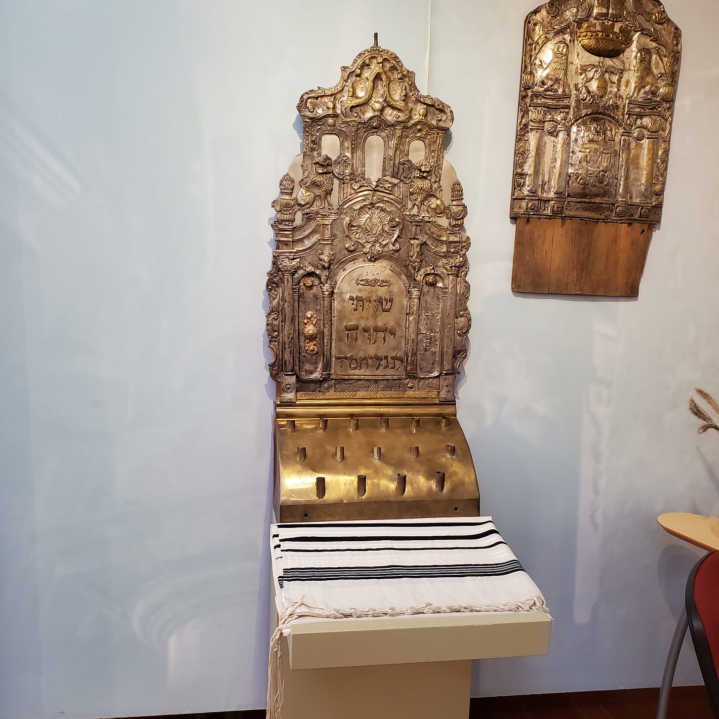 Three metal artifacts from the temple with Hebrew writing and elaborate decoration and Tallit.