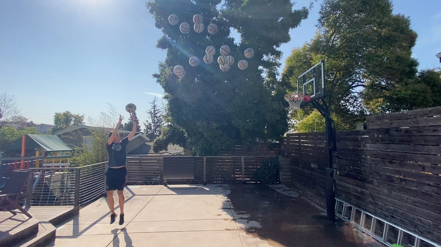 Some guy shooting lots and lots of basketballs at a hoop.