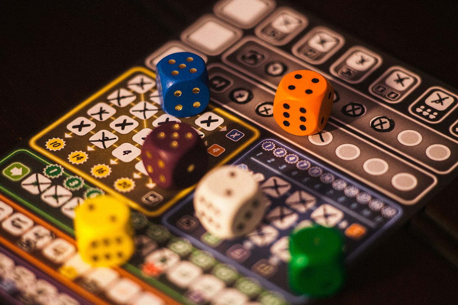 The roll-and-write game That’s Pretty Clever being played. Six dice are present on the paper sheet used for the game.