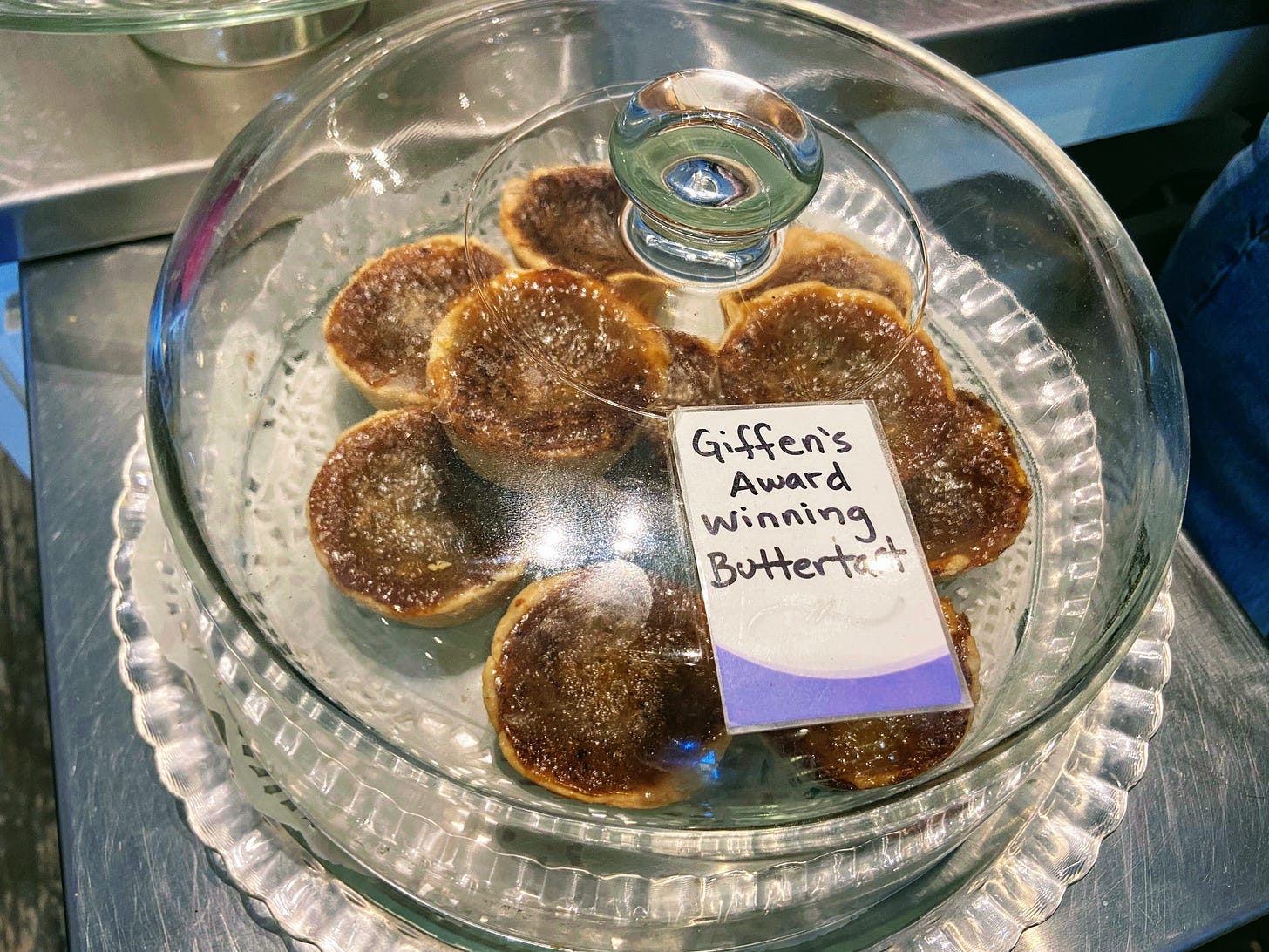 Butter tarts under a glass cover
