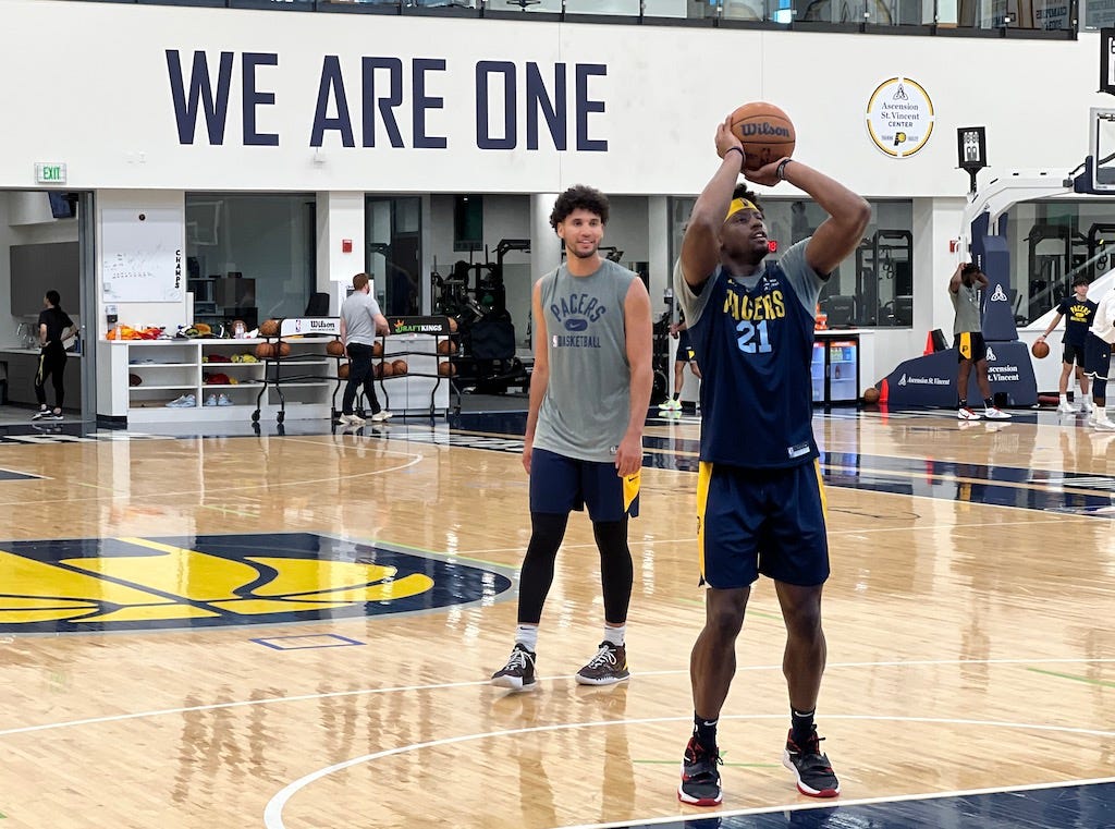 Terry Taylor shoots after Pacers practice with Bennie Boatwright.