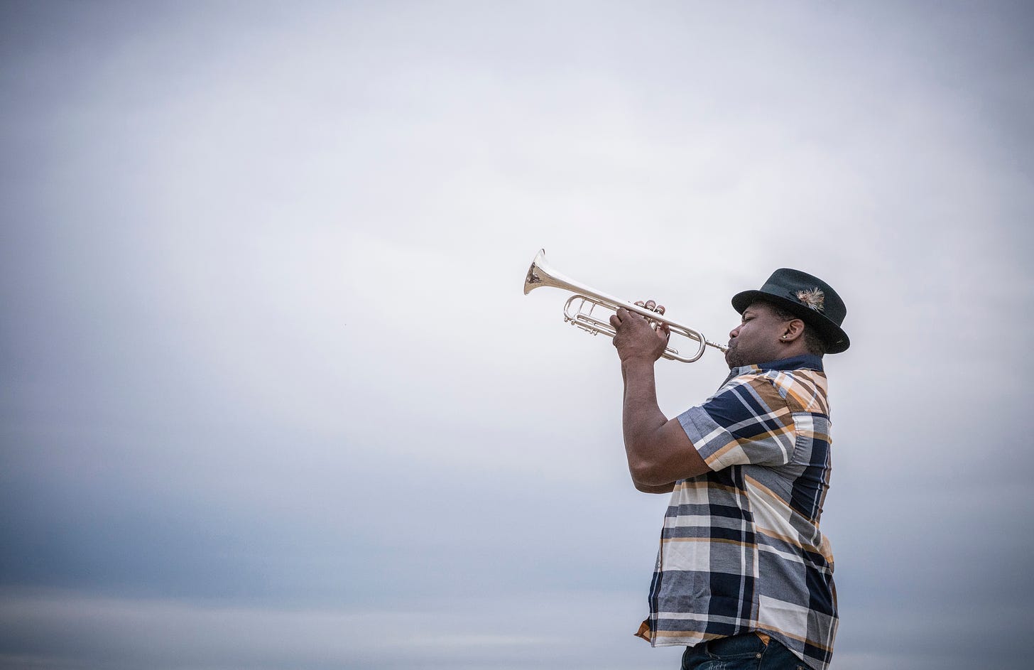Man in hat playing a trumpet