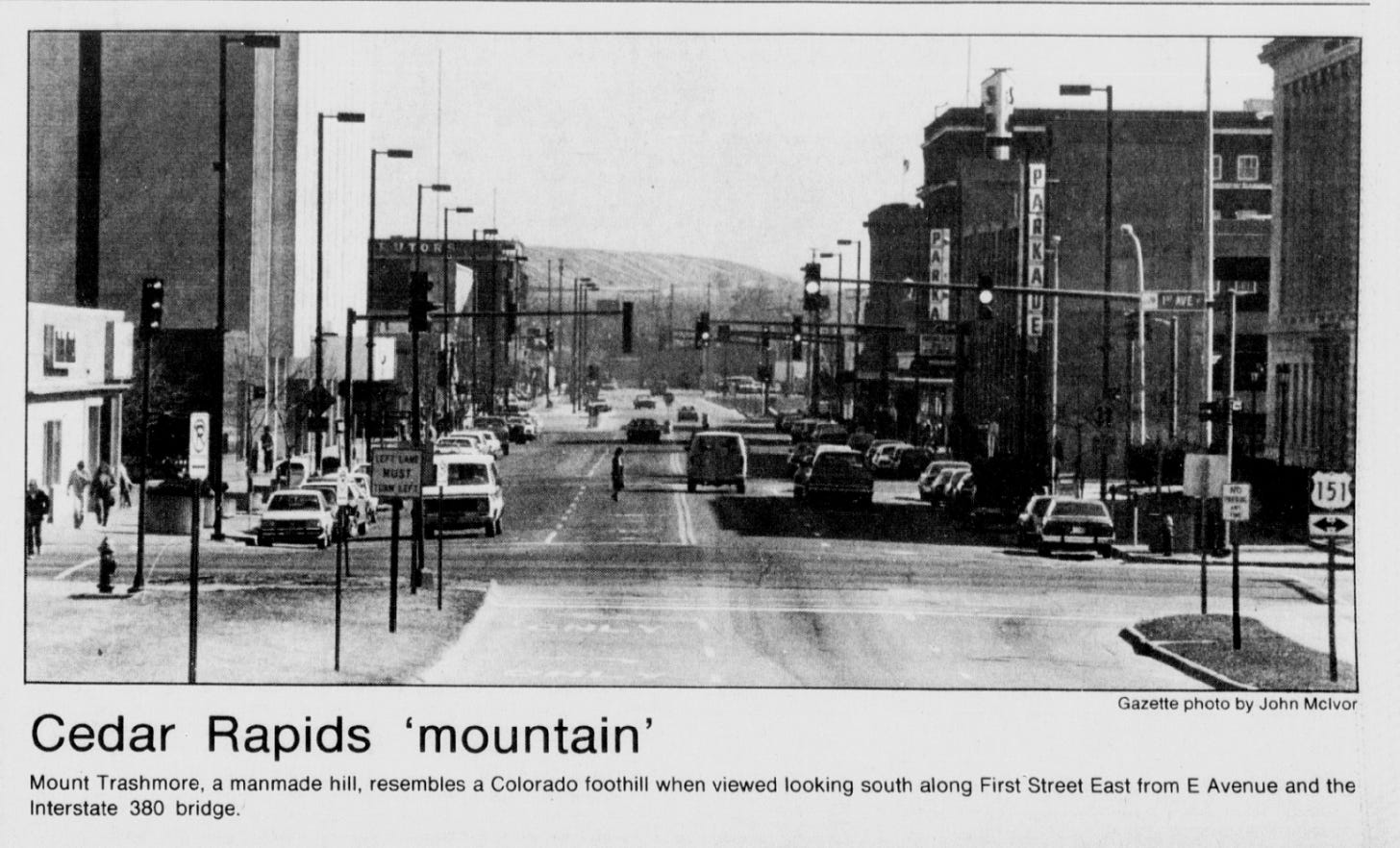 Gazette newspaper clipping with photo of Mount Trashmore at the end of a city block. Caption: Cedar Rapids ‘mountain’: Mount Trashmore, a manmade mountain, resembles a Colorado foothill when viewed looking south along First Street East from E Avenue and the Interstate 380 bridge.