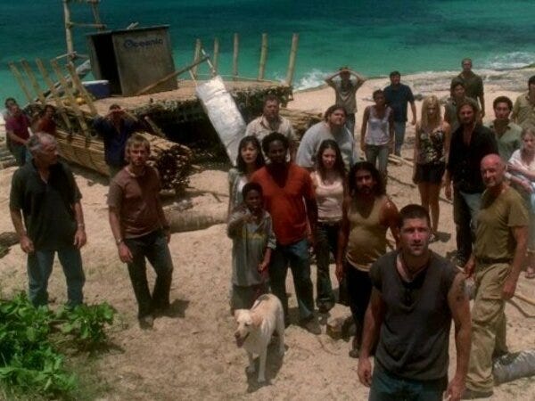 A shot of the beach with many members of the LOST main cast and several extras standing around the raft, which is readied to launch.