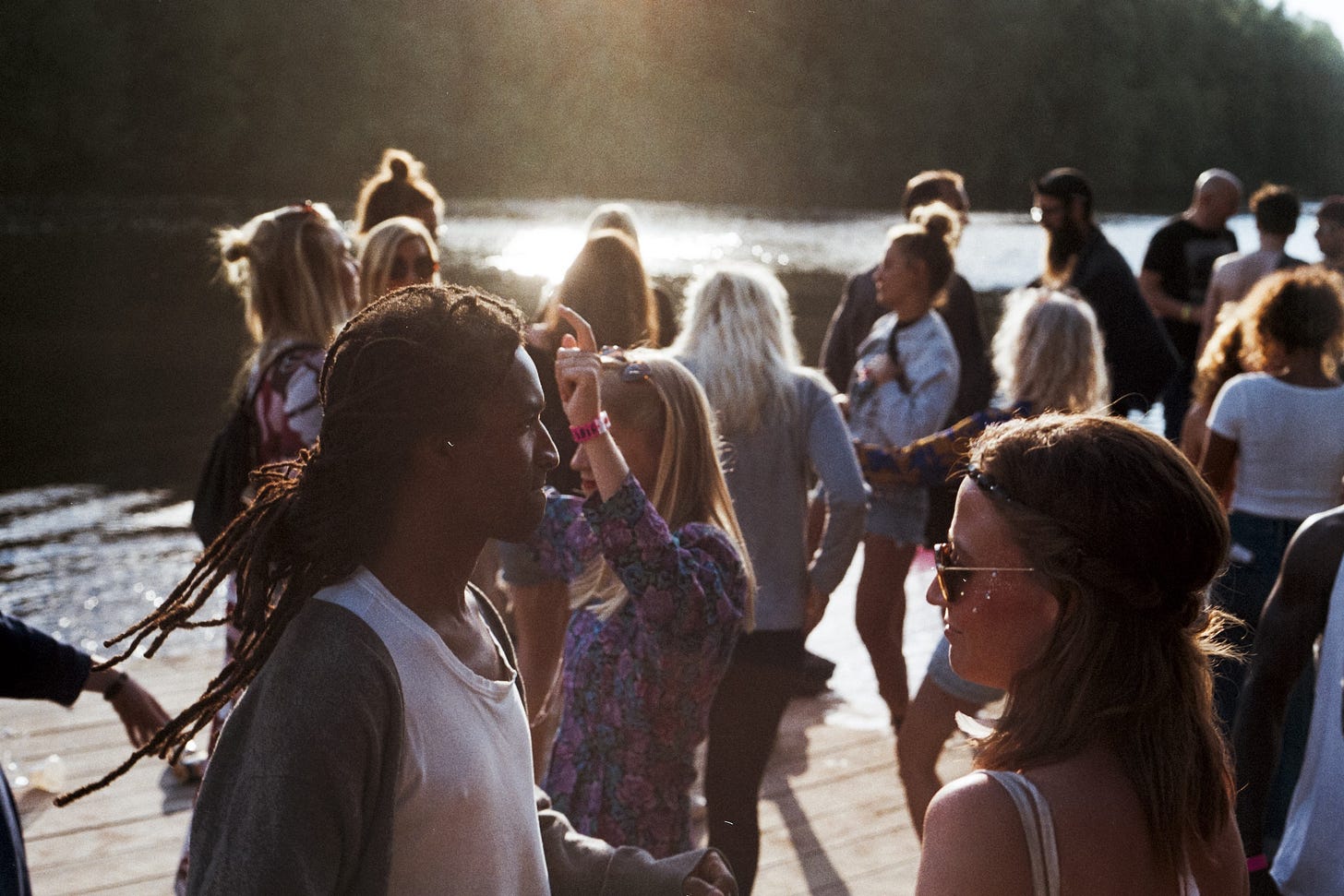 Young people dancing near water for poem by Larry G. Maguire