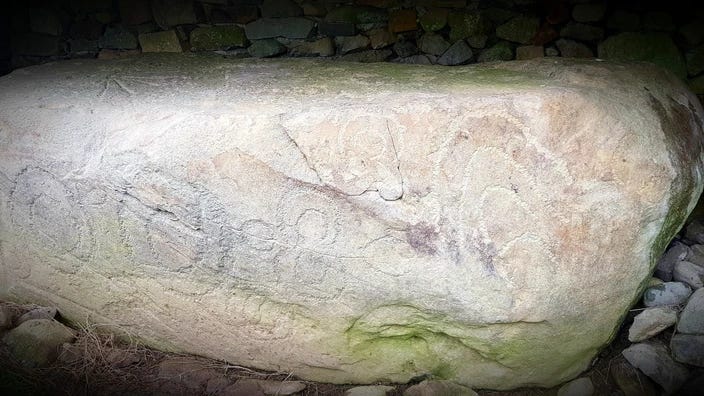 Kerbstone at Knowth with various circular picked designs.