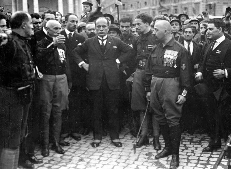 FILE - Italian Fascist leader Benito Mussolini, center, hands on hips, with members of the Fascist Party, in Rome, Italy, Oct. 28, 1922, following their March on Rome. Italy's failure to come to terms with its fascist past is more evident as it marks the 100th anniversary, Friday, Oct. 28, 2022, of the March on Rome that brought totalitarian dictator Benito Mussolini to power as the first postwar government led by a neo-fascist party takes office. (AP Photo, File)